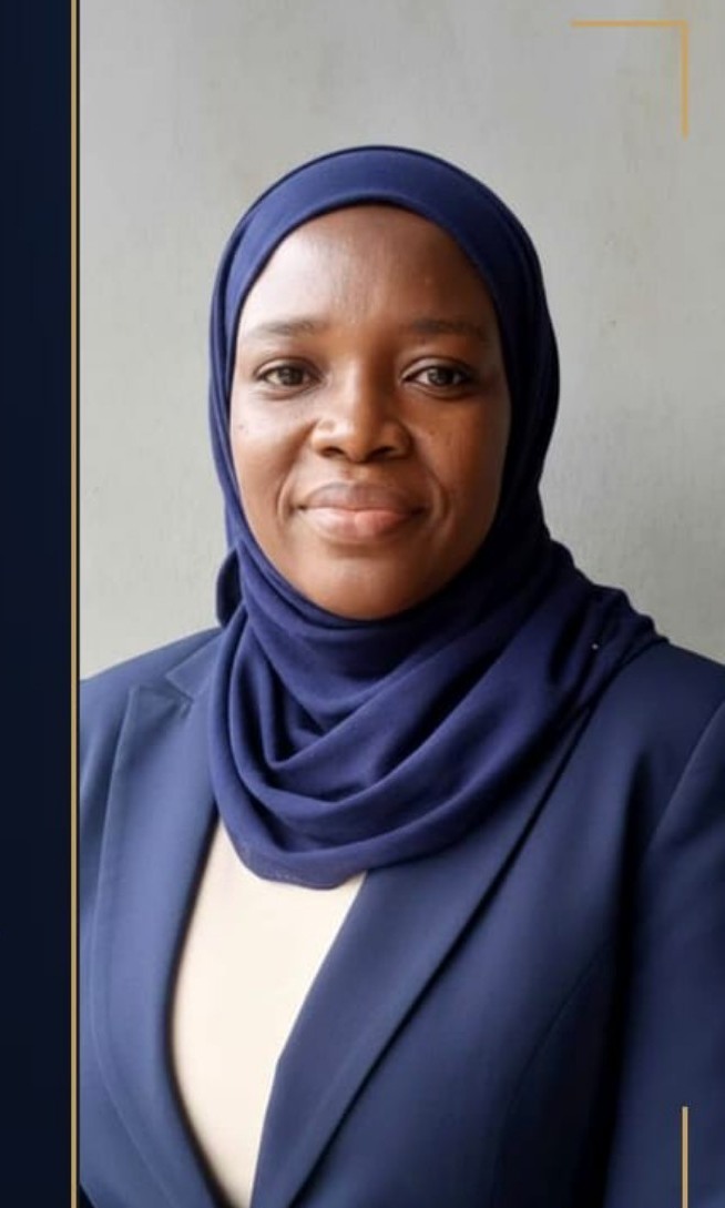 Portrait of Rashidat J. wearing a navy hijab and blazer